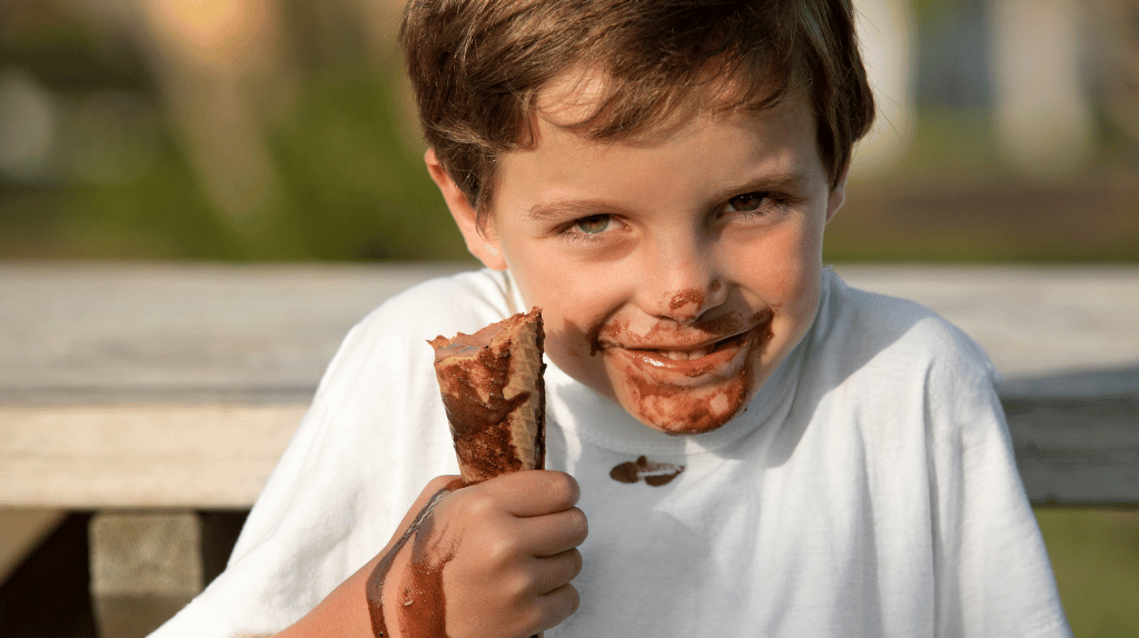 Boy holding ice-cream cone.